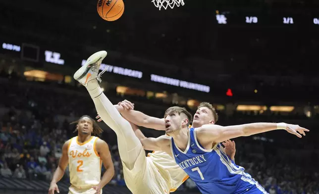 Tennessee's Igor Milicic Jr. shoots over Kentucky's Andrew Carr (7) as Tennessee's Chaz Lanier (2) watches during the first half in the Sweet 16 of the NCAA college basketball tournament Friday, March 28, 2025, in Indianapolis. (AP Photo/Michael Conroy)