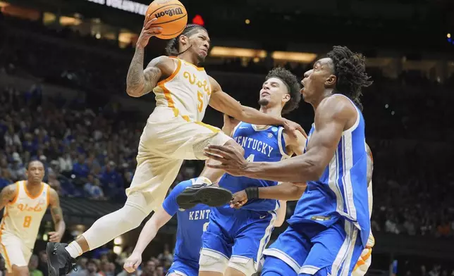 Tennessee's Zakai Zeigler (5) heads to the basket past Kentucky's Koby Brea, center, and Amari Williams, right, during the second half in the Sweet 16 of the NCAA college basketball tournament Friday, March 28, 2025, in Indianapolis. (AP Photo/Michael Conroy)