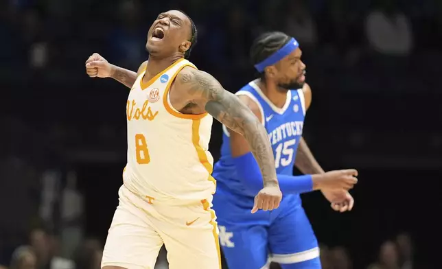Tennessee's Darlinstone Dubar (8) celebrates alongside Kentucky's Ansley Almonor (15) during the first half in the Sweet 16 of the NCAA college basketball tournament Friday, March 28, 2025, in Indianapolis. (AP Photo/Michael Conroy)