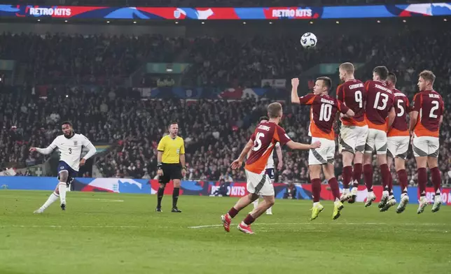 England's Reece James, left, scores his side's opening goal during a World Cup qualifying soccer match between England and Latvia at Wembley stadium in London, Monday, March 24, 2025. (AP Photo/Kin Cheung)