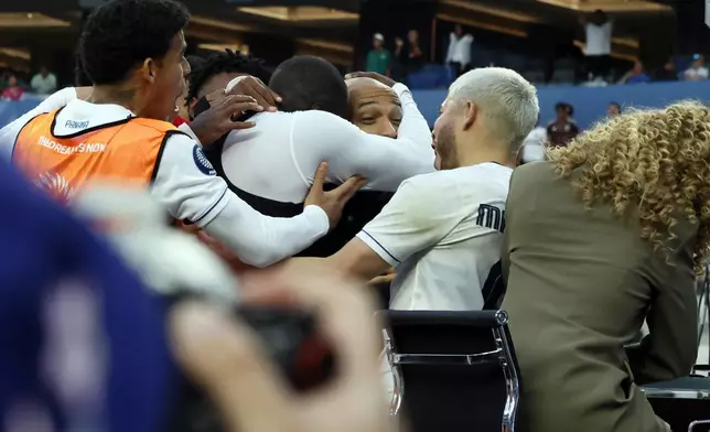 Panama's Cecilio Waterman Ruiz takes former French footballer Thierry Henry in his arm after he jumped on the nearby TV set after scoring against the United States during the second half of a CONCACAF Nations League semifinal soccer match Thursday, March 20, 2025, in Inglewood, Calif. (AP Photo/Etienne Laurent)