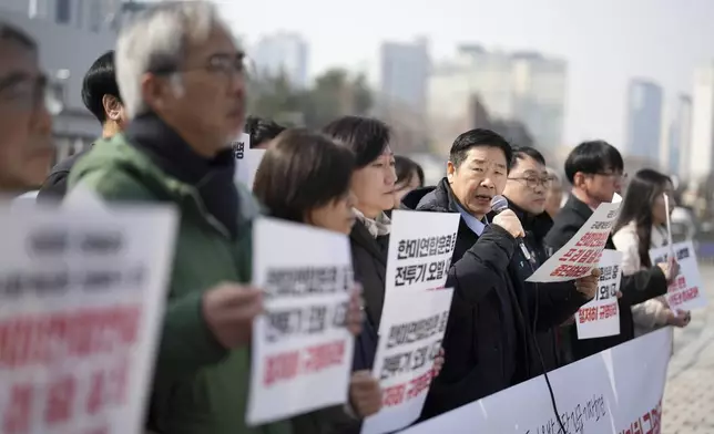 Protesters attend a press conference demanding to stop the upcoming Freedom Shield military exercise between the U.S. and South Korea and also demanding to investigate the cause thoroughly about fighter jets accidentally dropped eight bombs on a civilian area, in Seoul, South Korea, Friday, March 7, 2025. Banners read "Stop the Freedom Shield military exercise between the U.S. and South Korea." (AP Photo/Lee Jin-man)