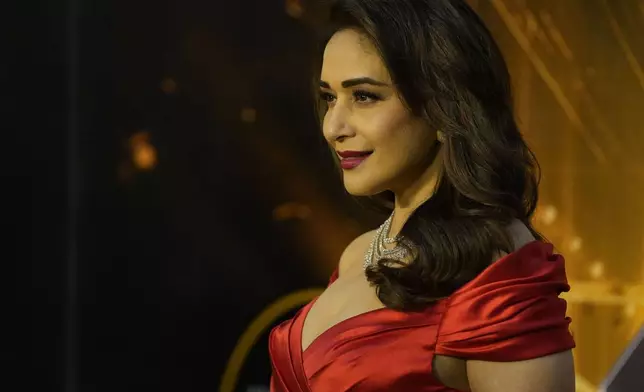 Bollywood actor Madhuri Dixit poses for photograph as she arrives for the International Indian Film Academy (IIFA) awards ceremony in Jaipur, India, Sunday, March 9, 2025. (AP Photo/Deepak Sharma)