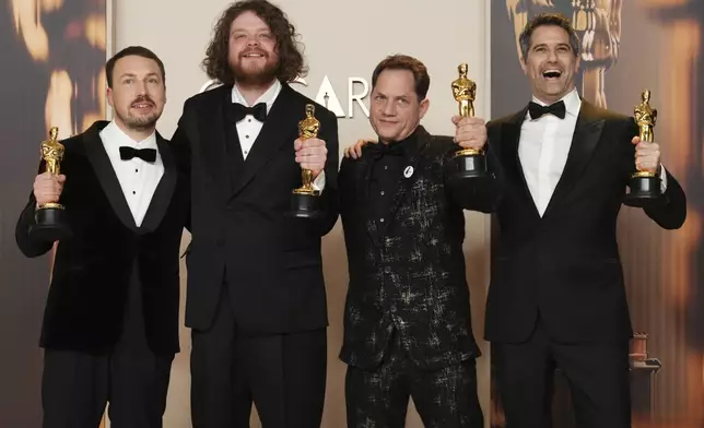 From left, Gints Zilbalodis, Matiss Kaza, Ron Dyens and Gregory Zalcman, winners of the award for best animated feature film for "Flow," pose in the press room at the Oscars on Sunday, March 2, 2025, at the Dolby Theatre in Los Angeles. (Photo by Jordan Strauss/Invision/AP)