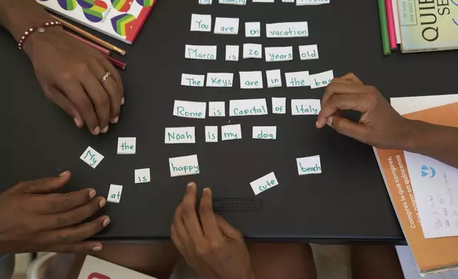 Migrants receive English lessons at Casa Frida, a shelter that supports LGBTQ+ migrants, in Tapachula, Chiapas state, Mexico, Wednesday, March 12, 2025. (AP Photo/Moises Castillo)
