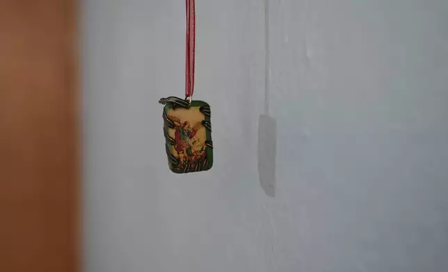 A religious image hangs in a room at Casa Frida, a shelter that supports LGBTQ+ migrants, in Mexico City, Tuesday, Feb. 18, 2025. (AP Photo/Eduardo Verdugo)