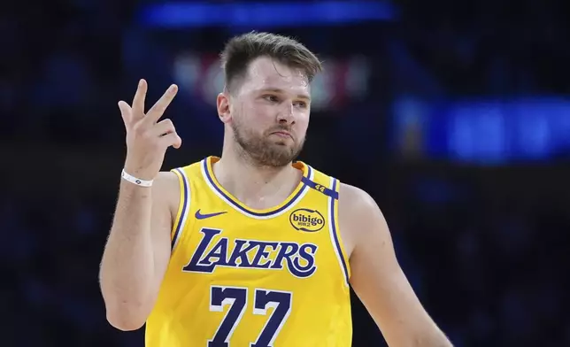 Los Angeles Lakers' Luka Doncic (77) celebrates his three-point basket during the first half of an NBA basketball game against the New Orleans Pelicans Tuesday, March 4, 2025, in Los Angeles. (AP Photo/Jae C. Hong)