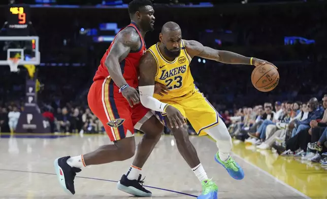 Los Angeles Lakers' LeBron James (23) is defended by New Orleans Pelicans' Zion Williamson (1) during the second half of an NBA basketball game Tuesday, March 4, 2025, in Los Angeles. (AP Photo/Jae C. Hong)