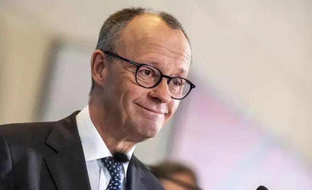Friedrich Merz, CDU/CSU parliamentary group leader in the Bundestag and CDU federal chairman, makes a statement after the parliamentary group meeting in the Bundestag, Berlin, Friday, March 14, 2025. (Michael Kappeler/dpa via AP)