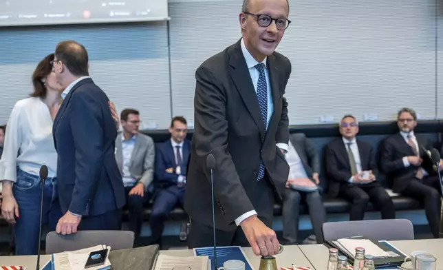 Friedrich Merz, CDU/CSU parliamentary group leader in the Bundestag and CDU federal chairman, speaks at the start of the parliamentary group meeting in the Bundestag, Berlin, Friday, March 14, 2025. (Michael Kappeler/dpa via AP)