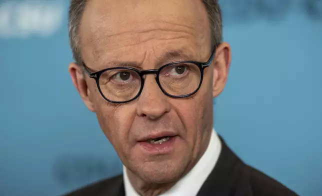 Friedrich Merz, CDU/CSU parliamentary group leader in the Bundestag and CDU federal chairman, makes a statement after the parliamentary group meeting in the Bundestag, Berlin, Friday, March 14, 2025. (Michael Kappeler/dpa via AP)