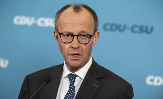 Friedrich Merz, CDU/CSU parliamentary group leader in the Bundestag and CDU federal chairman, makes a statement after the parliamentary group meeting in the Bundestag, Berlin, Friday, March 14, 2025. (Michael Kappeler/dpa via AP)