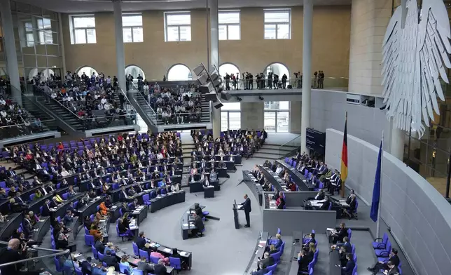 German opposition leader and Christian Democratic Union party chairman Friedrich Merz, center, delivers his speech during a meeting of the German federal parliament, Bundestag, at the Reichstag building in Berlin, Germany, Thursday, March 13, 2025. (AP Photo/Ebrahim Noroozi)