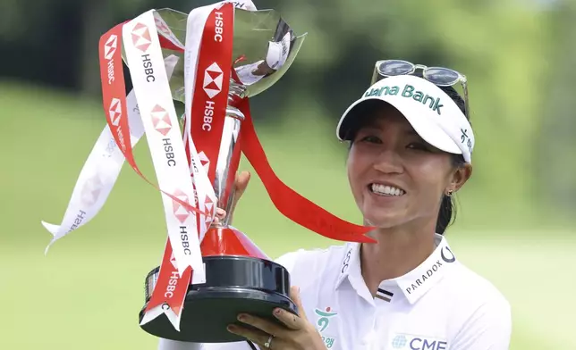 Lydia Ko of New Zealand celebrates with the trophy after winning the the HSBC Women's World Championship 2025 at Sentosa Golf Club in Singapore, Sunday, March 2, 2025. (AP Photo/Suhaimi Abdullah)
