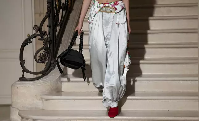 A model wears a creation as part of the Kenzo Fall/Winter 2025-2026 Womenswear collection presented in Paris, Friday, March 7, 2025. (Photo by Scott A Garfitt/Invision/AP)