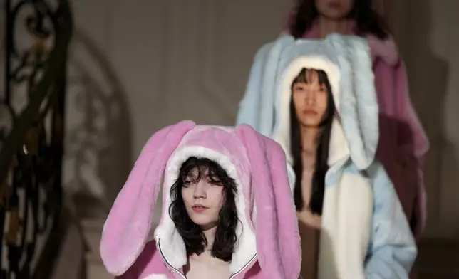 Models wear creations as part of the Kenzo Fall/Winter 2025-2026 Womenswear collection presented in Paris, Friday, March 7, 2025. (Photo by Scott A Garfitt/Invision/AP)