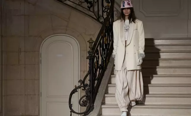 A model wears a creation as part of the Kenzo Fall/Winter 2025-2026 Womenswear collection presented in Paris, Friday, March 7, 2025. (Photo by Scott A Garfitt/Invision/AP)