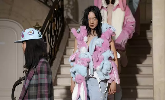 Models wear creations as part of the Kenzo Fall/Winter 2025-2026 Womenswear collection presented in Paris, Friday, March 7, 2025. (Photo by Scott A Garfitt/Invision/AP)