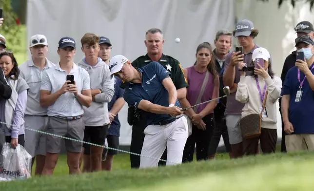 Justin Thomas hits from in front of the gallery on the 18th hole during the first round of the Valspar Championship golf tournament Thursday, March 20, 2025, at Innisbrook in Palm Harbor, Fla. (AP Photo/Chris O'Meara)