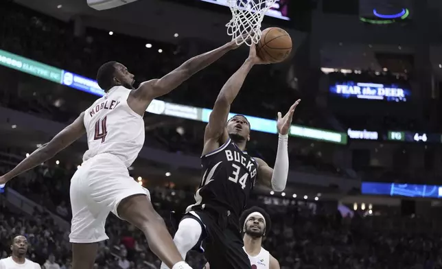 Milwaukee Bucks' Giannis Antetokounmpo shoots past Cleveland Cavaliers' Evan Mobley during the first half of an NBA basketball game Sunday, Mar. 9, 2025, in Milwaukee. (AP Photo/Morry Gash)