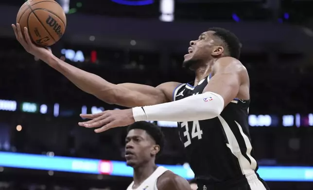 Milwaukee Bucks' Giannis Antetokounmpo shoots past Cleveland Cavaliers' De'Andre Hunter during the first half of an NBA basketball game Sunday, Mar. 9, 2025, in Milwaukee. (AP Photo/Morry Gash)