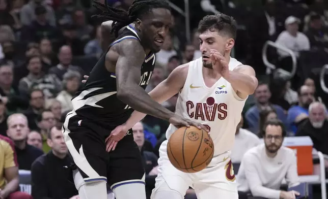 Cleveland Cavaliers' Ty Jerome knocks the ball from Milwaukee Bucks' Taurean Prince during the first half of an NBA basketball game Sunday, Mar. 9, 2025, in Milwaukee. (AP Photo/Morry Gash)