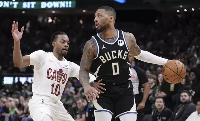 Milwaukee Bucks' Damian Lillard tries to get past Cleveland Cavaliers' Darius Garland during the first half of an NBA basketball game Sunday, Mar. 9, 2025, in Milwaukee. (AP Photo/Morry Gash)