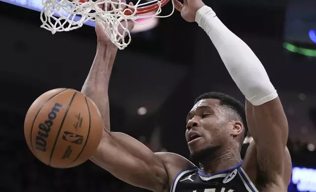Milwaukee Bucks' Giannis Antetokounmpo dunks during the first half of an NBA basketball game Sunday, Mar. 9, 2025, in Milwaukee. (AP Photo/Morry Gash)