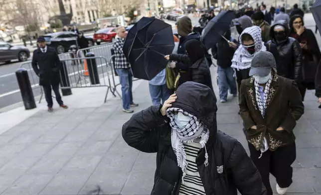 Students from Columbia University arrive at the Manhattan federal court prior to the deportation case of Mahmoud Khalil, Wednesday, March 12, 2025, in New York. (AP Photo/Stefan Jeremiah)