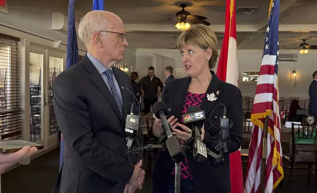 U.S. Sen. Peter Welch, a Democrat from Vermont, left, and Marie-Claude Bibeau, a Canadian member of parliament representing Compton-Stanstead, talk at a roundtable event about the Trump administration's tariffs with U.S. and Canadian business owners, Tuesday, March 18, 2025 in Newport, Vt. (AP Photo/Amanda Swinhart)