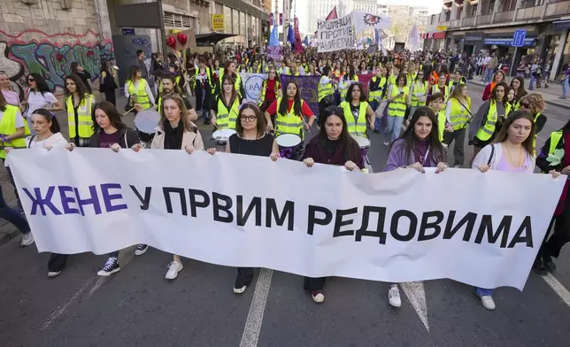 Women hold a banner reads: "Women in the front rows" during a march in support to the women on International Women's Day in Belgrade, Serbia, Saturday, March 8, 2025. (AP Photo/Darko Vojinovic)