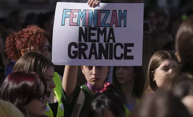 A girl holds a banner reads: "Feminism has no boundaries" during march in support of women on the International Women's Day in Belgrade, Serbia, Saturday, March 8, 2025. (AP Photo/Darko Vojinovic)