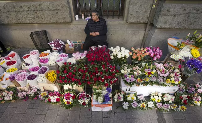 A street vendor sells flowers during the International Women's Day in Belgrade, Serbia, Saturday, March 8, 2025. (AP Photo/Darko Vojinovic)
