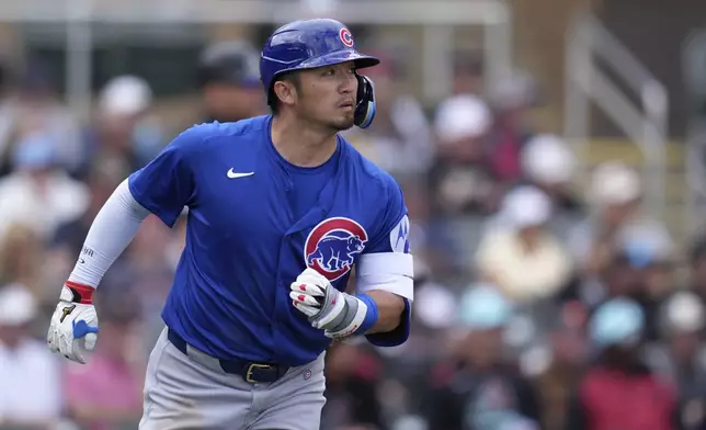 Chicago Cubs' Seiya Suzuki, of Japan, watches the flight of a fly ball out against the Arizona Diamondbacks during the third inning of a spring training baseball game Monday, March 3, 2025, in Scottsdale, Ariz. (AP Photo/Ross D. Franklin)