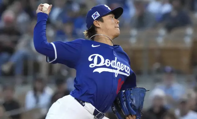 Los Angeles Dodgers pitcher Yoshinobu Yamamoto (18) throws during the second inning of a spring training baseball game against the Cincinnati Reds, Tuesday, March. 4, 2025, in Phoenix. (AP Photo/Darryl Webb)