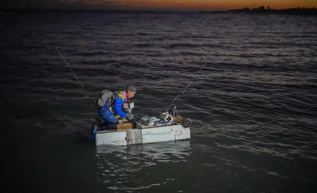 A man on a makeshift raft prepares to fish at dawn in Cojimar, east of Havana, Wednesday, March 12, 2025. (AP Photo/Ramon Espinosa)