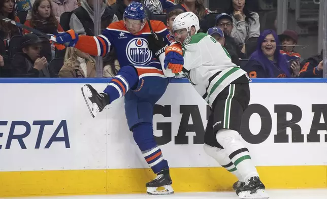 Dallas Stars' Lian Bichsel (6) checks Edmonton Oilers' Jeff Skinner (53) during the second period of an NHL game in Edmonton on Wednesday, March 26, 2025. (Jason Franson/The Canadian Press via AP)