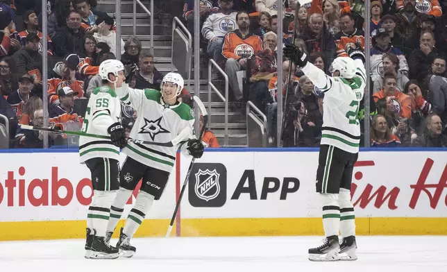 Dallas Stars' Thomas Harley (55), Jason Robertson (21) and Roope Hintz (24) celebrate a goal against the Edmonton Oilers during the second period of an NHL game in Edmonton on Wednesday, March 26, 2025. (Jason Franson/The Canadian Press via AP)