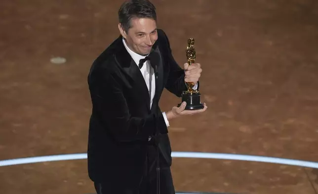 Sean Baker accepts the award for best original screenplay for "Anora" during the Oscars on Sunday, March 2, 2025, at the Dolby Theatre in Los Angeles. (AP Photo/Chris Pizzello)