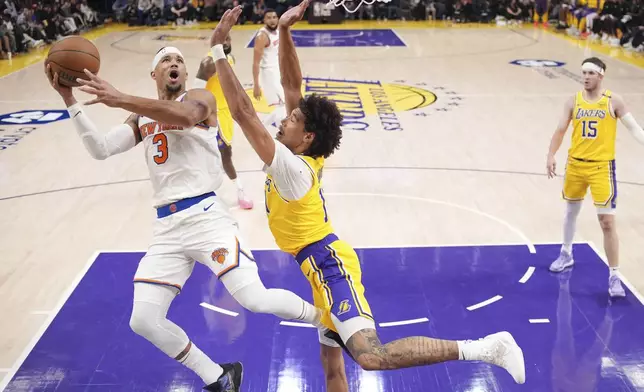 New York Knicks guard Josh Hart, left, shoots as Los Angeles Lakers center Jaxson Hayes defends during the first half of an NBA basketball game Thursday, March 6, 2025, in Los Angeles. (AP Photo/Mark J. Terrill)