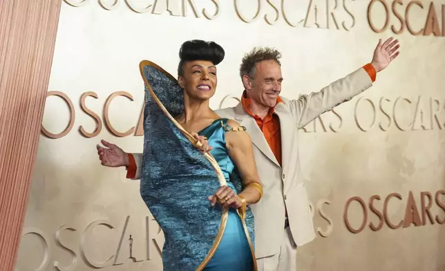 Kayo Shekoni, left, and Johan Grimonprez arrive at the Oscars on Sunday, March 2, 2025, at the Dolby Theatre in Los Angeles. (AP Photo/Jae C. Hong)
