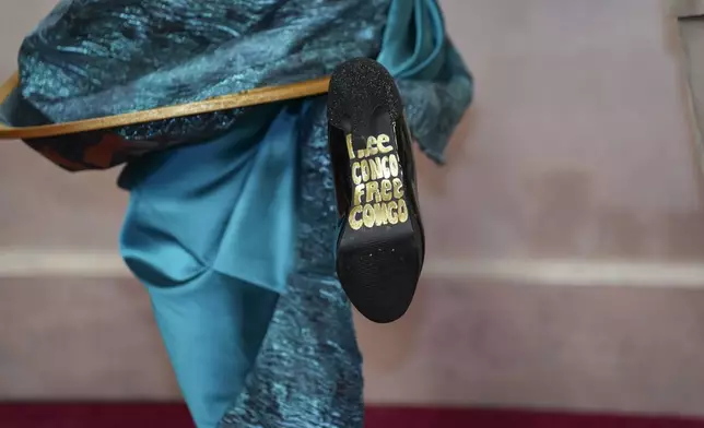 Kayo Shekoni shows the bottom of her shoe as she arrives at the Oscars on Sunday, March 2, 2025, at the Dolby Theatre in Los Angeles. (AP Photo/Jae C. Hong)