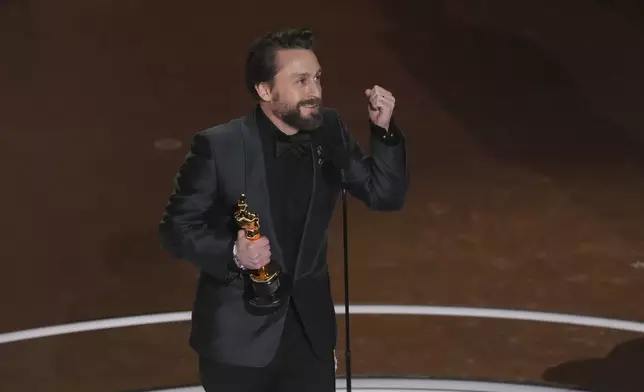Kieran Culkin accepts the award for best performance by an actor in a supporting role for "A Real Pain" during the Oscars on Sunday, March 2, 2025, at the Dolby Theatre in Los Angeles. (AP Photo/Chris Pizzello)