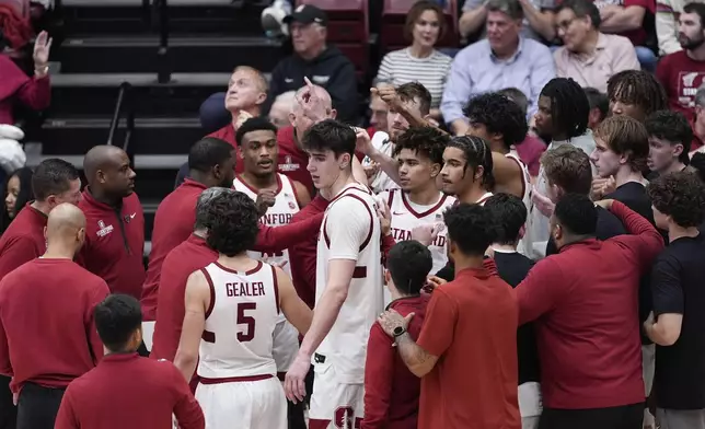 Stanford forward Maxime Raynaud, center, breaks a huddle during a timeout in the second half of an NCAA college basketball game against California, Saturday, Feb. 22, 2025, in Stanford, Calif. (AP Photo/Godofredo A. Vásquez)