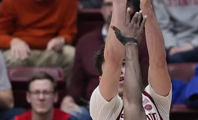 Stanford forward Maxime Raynaud, rear, shoots a 3-point basket over California center Mady Sissoko during the second half of an NCAA college basketball game Saturday, Feb. 22, 2025, in Stanford, Calif. (AP Photo/Godofredo A. Vásquez)
