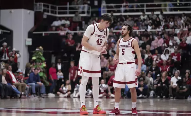 Stanford forward Maxime Raynaud (42) talks with guard Benny Gealer (5) during the second half of an NCAA college basketball game against California, Saturday, Feb. 22, 2025, in Stanford, Calif. (AP Photo/Godofredo A. Vásquez)