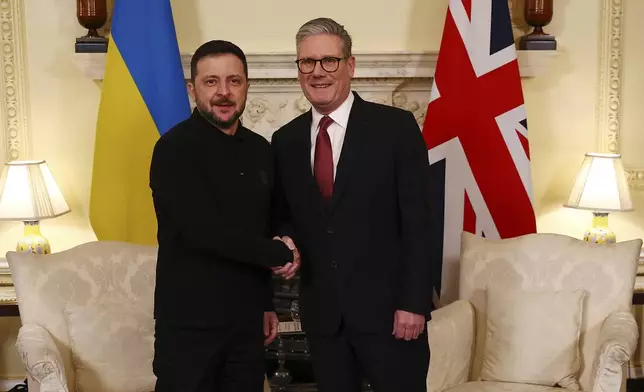 Britain's Prime Minister Keir Starmer, right, greets Ukraine's President Volodymyr Zelenskyy, left, for a meeting at 10 Downing Street in London, England, Saturday, March 1, 2025. (Peter Nicholls/Pool Photo via AP)