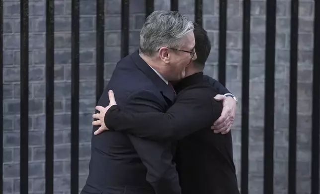 Britain's Prime Minister Keir Starmer, embraces and greets Ukraine's President Volodymyr Zelenskyy in Downing Street, London, Saturday, March 1, 2025. (AP Photo/Kin Cheung)