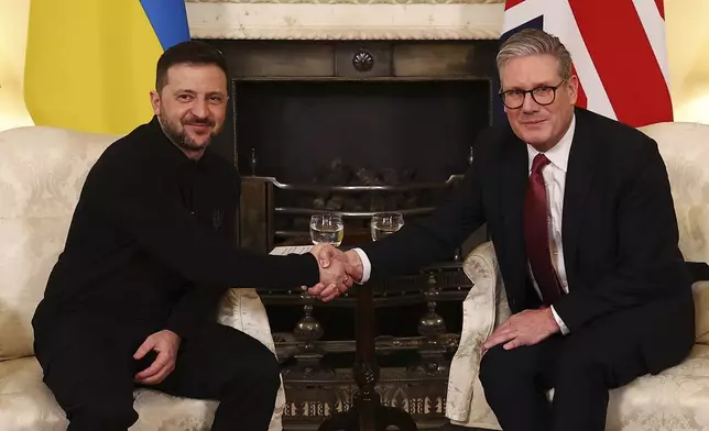 Britain's Prime Minister Keir Starmer, right, and Ukraine's President Volodymyr Zelenskyy, left, shake hands during a meeting at 10 Downing Street in London, England, Saturday, March 1, 2025. (Peter Nicholls/Pool Photo via AP)