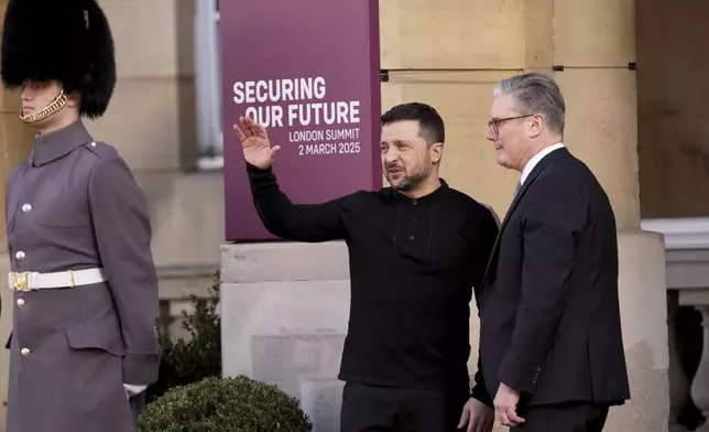 Britain's Prime Minister Keir Starmer, right, greets Ukraine's President Volodymyr Zelenskyy as he arrives for a summit on Ukraine at Lancaster House in London, Sunday, March 2, 2025. (AP Photo/Christophe Ena, Pool)